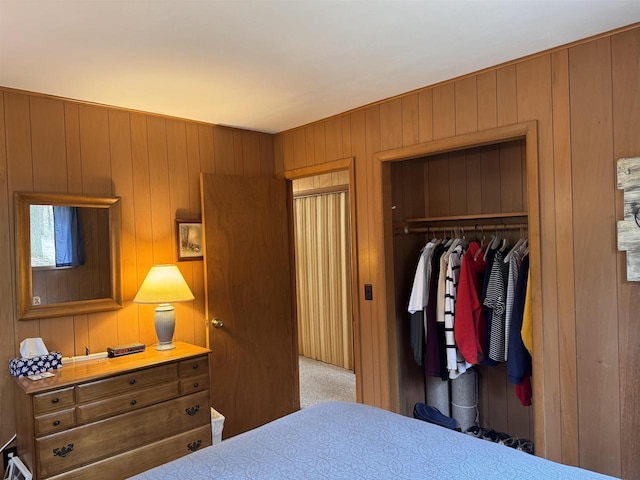 bedroom featuring a closet and wood walls