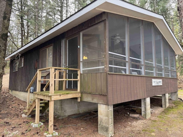 view of side of property featuring a sunroom and a carport