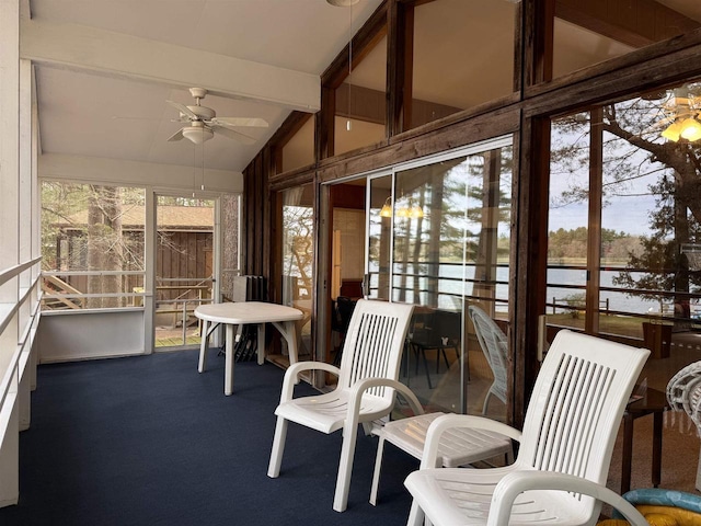 sunroom with beam ceiling and ceiling fan