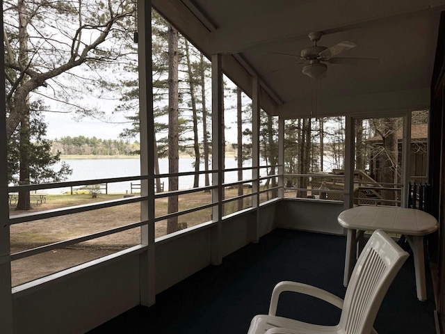 sunroom with a water view, a healthy amount of sunlight, and a ceiling fan