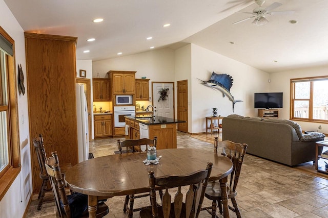 6258 Ninebark Rd, Abrams, WI 54153 - dining room with lofted ceiling, a ceiling fan, recessed lighting, and light stone finish floors