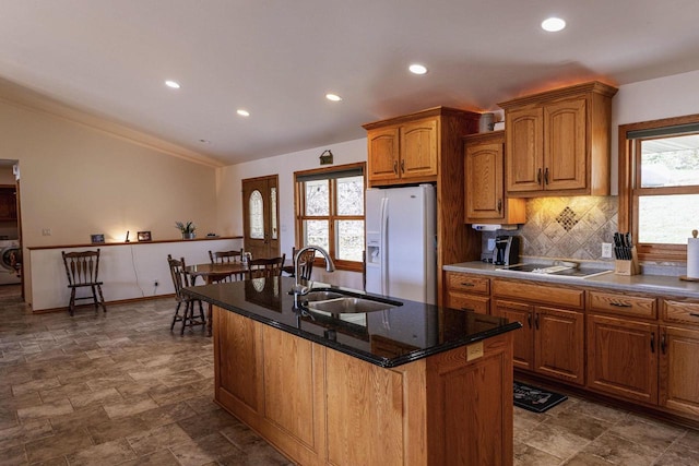 6258 Ninebark Rd, Abrams, WI 54153 - kitchen with white refrigerator with ice dispenser, a sink, stone finish flooring, decorative backsplash, and recessed lighting