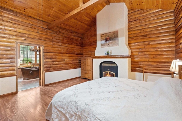 W2470 County Road B, Montello, WI 53949 - bedroom with rustic walls, wooden ceiling with exposed beams, a warm lit fireplace, wood finished floors, and baseboards