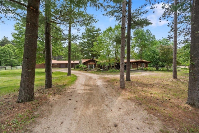 W2470 County Road B, Montello, WI 53949 - view of front of home featuring driveway, a carport, and view of wooded area