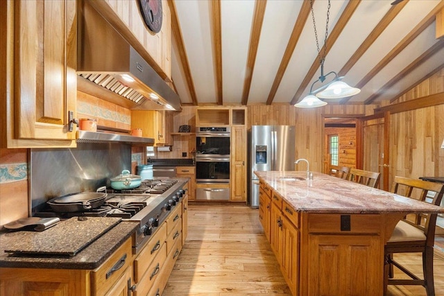 W2470 County Road B, Montello, WI 53949 - kitchen with exhaust hood, appliances with stainless steel finishes, a warming drawer, a kitchen breakfast bar, and a sink