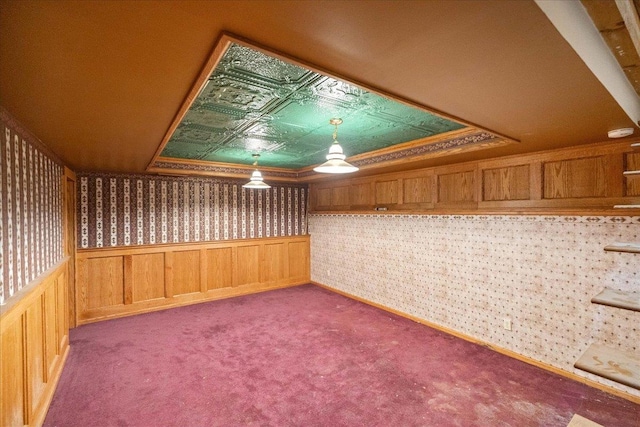 W2470 County Road B, Montello, WI 53949 - spare room featuring wallpapered walls, carpet floors, a raised ceiling, and a wainscoted wall