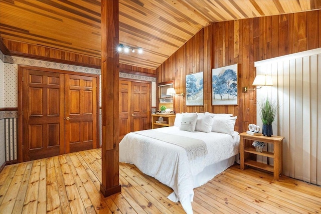 W2470 County Road B, Montello, WI 53949 - bedroom featuring vaulted ceiling, light wood-style flooring, wood walls, wooden ceiling, and wallpapered walls