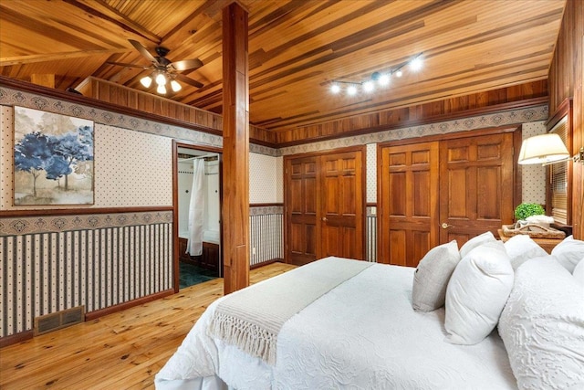 W2470 County Road B, Montello, WI 53949 - bedroom featuring wallpapered walls, hardwood / wood-style flooring, wooden ceiling, and two closets