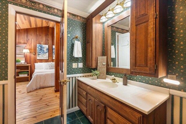 W2470 County Road B, Montello, WI 53949 - bathroom featuring wallpapered walls, vanity, ensuite bathroom, and wainscoting