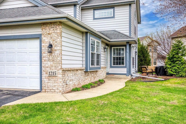 exterior space with a yard, a shingled roof, and stone siding