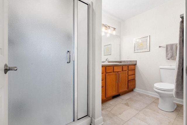 bathroom featuring vanity, toilet, baseboards, and a shower stall