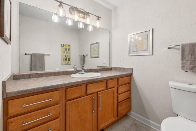 bathroom featuring toilet, tile patterned floors, and vanity