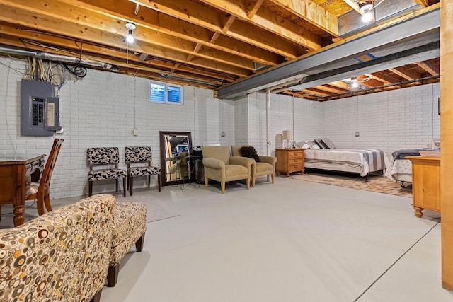 unfinished below grade area featuring electric panel and brick wall