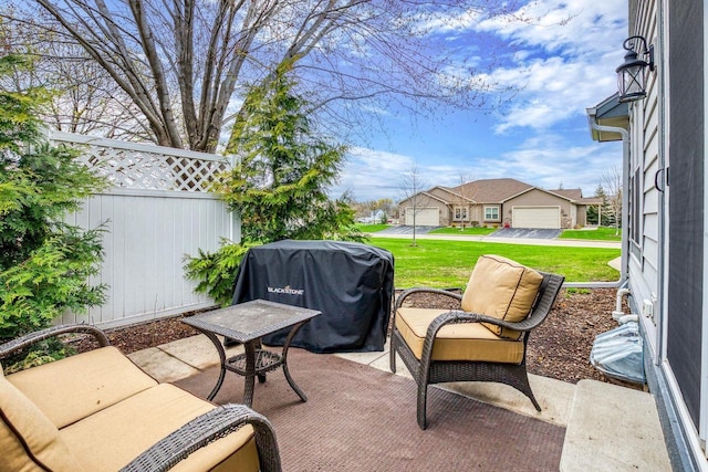 view of patio featuring fence and area for grilling