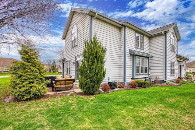 view of property exterior with a yard, a patio area, an outdoor hangout area, and central air condition unit
