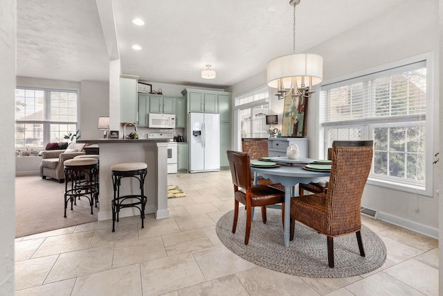 dining space featuring baseboards and recessed lighting