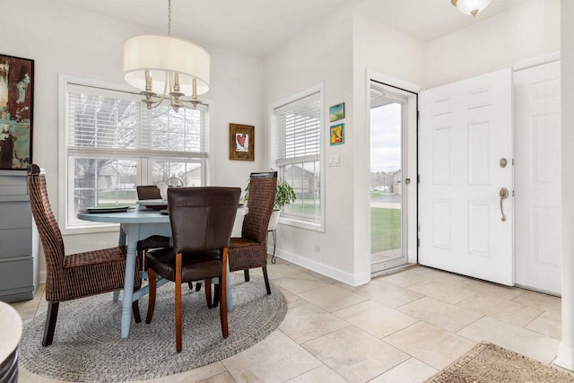 dining space featuring a chandelier, baseboards, and light tile patterned floors