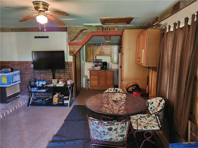 carpeted dining area with a ceiling fan