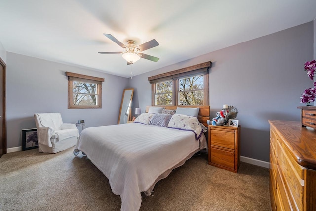 carpeted bedroom featuring ceiling fan and baseboards