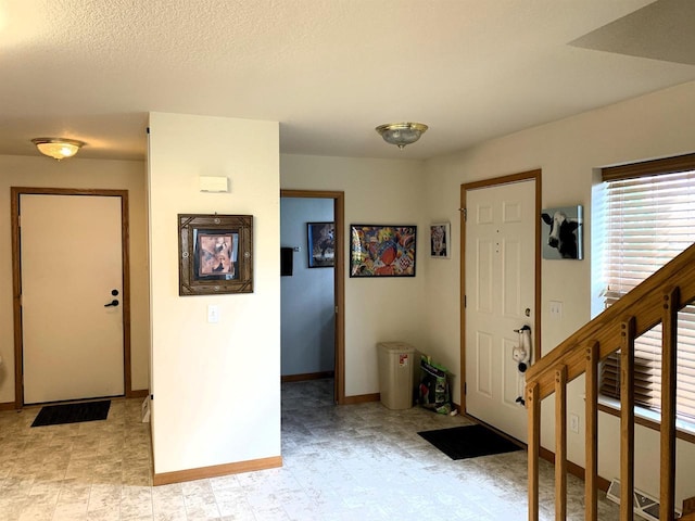 foyer entrance with baseboards