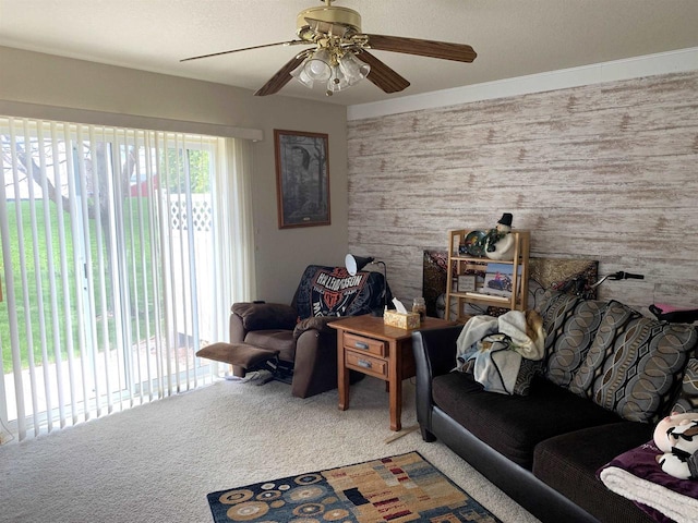 living area with ceiling fan and carpet