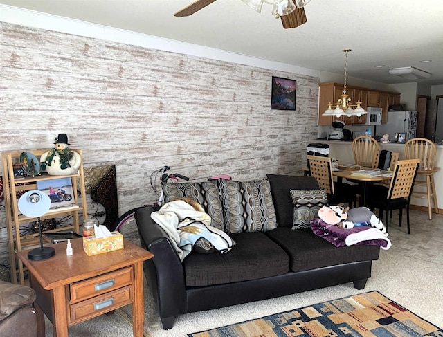 living room featuring ceiling fan with notable chandelier