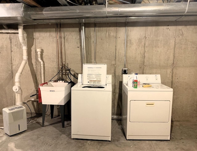 laundry area with a sink, laundry area, and washer and dryer