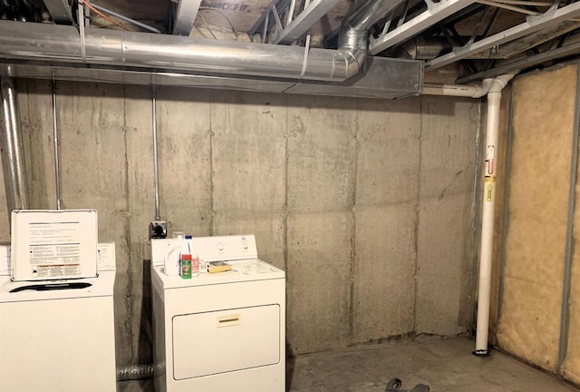 unfinished below grade area featuring independent washer and dryer