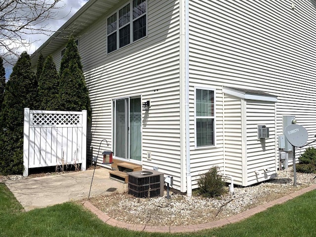 rear view of property with a patio and central AC