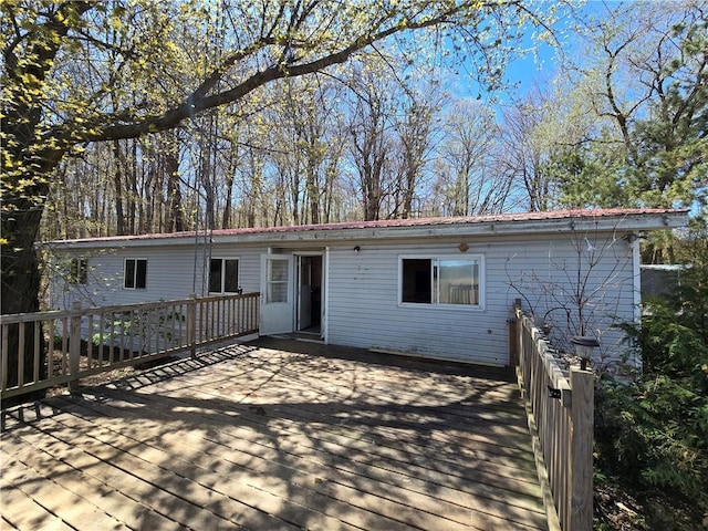2111 4th Ave, Chetek, WI 54728 - back of property featuring a deck and metal roof