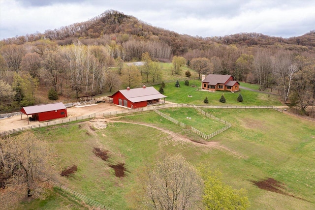 aerial view with a mountain view, a rural view, and a forest view