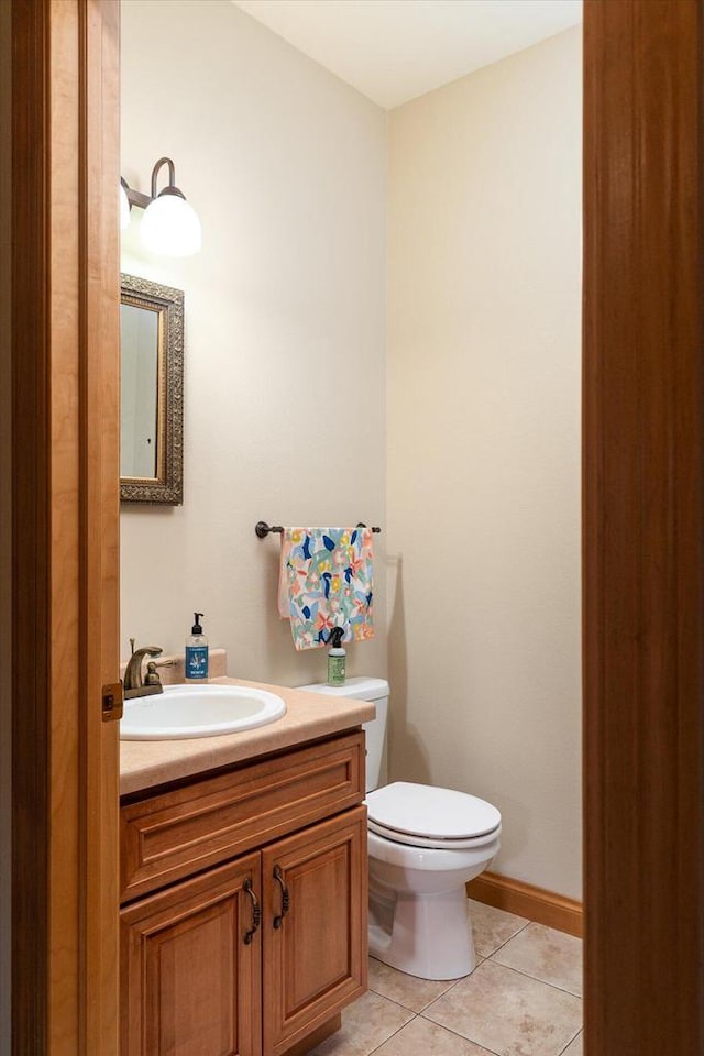 bathroom with vanity, toilet, and tile patterned floors