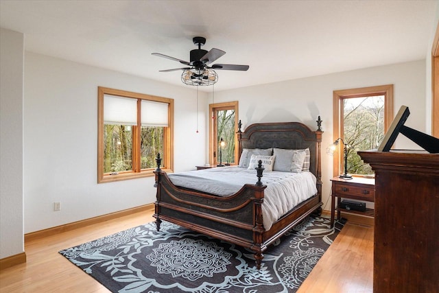 bedroom featuring baseboards, ceiling fan, and wood finished floors