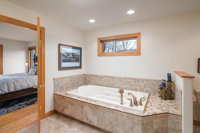 ensuite bathroom featuring recessed lighting, toilet, a bath, tile patterned flooring, and connected bathroom