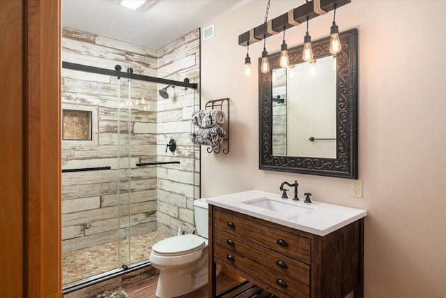 full bath with vanity, toilet, a shower stall, and wood finished floors
