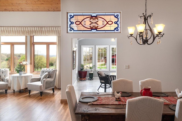 dining area featuring a notable chandelier and light wood-type flooring