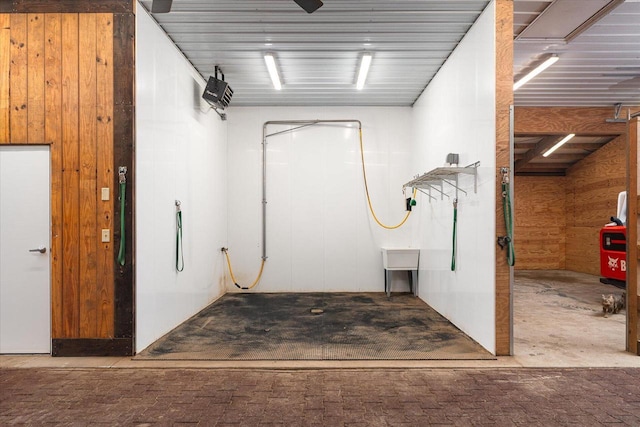 garage featuring wood walls