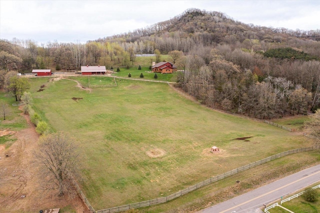 birds eye view of property featuring a rural view and a wooded view