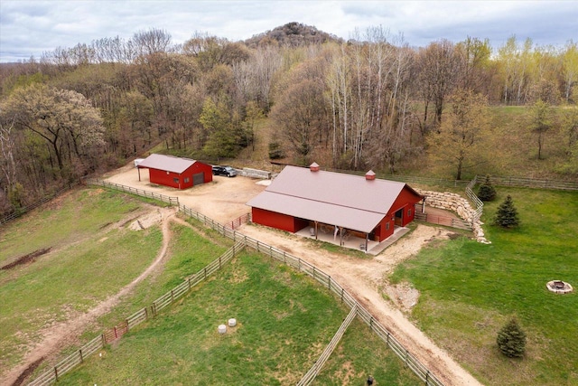 bird's eye view with a wooded view and a rural view