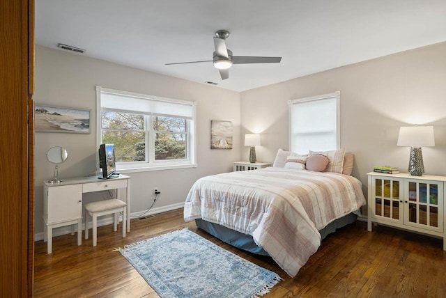 bedroom with ceiling fan, baseboards, visible vents, and wood finished floors