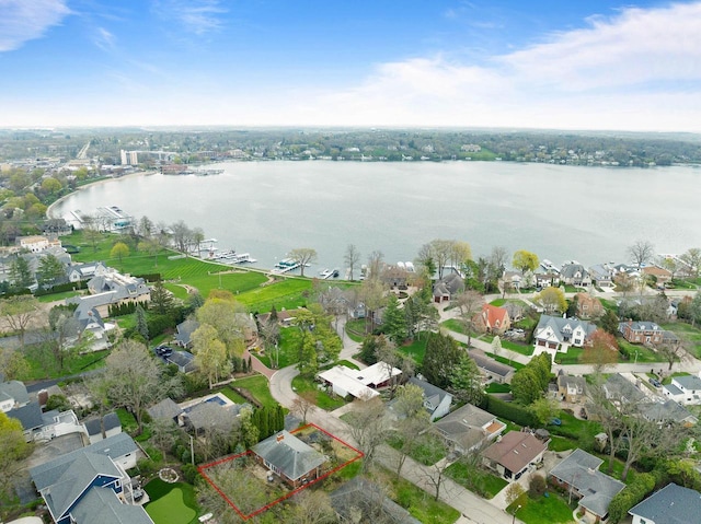 drone / aerial view with a water view and a residential view