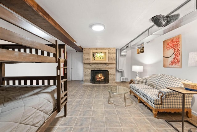 tiled bedroom with a brick fireplace