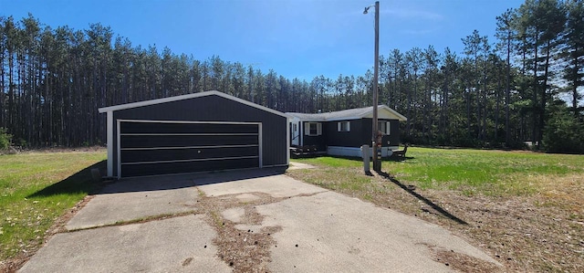N7120 Sullivan Ln, New Lisbon, WI 53950 - manufactured / mobile home featuring a front yard, a wooded view, and a garage