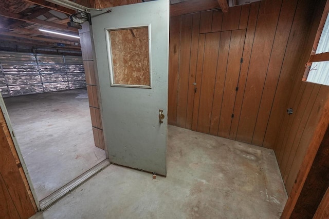 N7120 Sullivan Ln, New Lisbon, WI 53950 - hallway featuring concrete floors and wooden walls