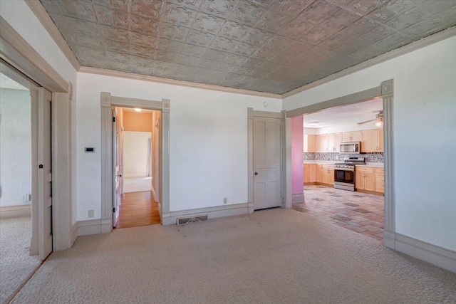 3756 E County Rd N, Milton, WI 53563 - unfurnished bedroom with an ornate ceiling, light colored carpet, ornamental molding, connected bathroom, and baseboards