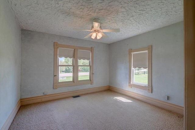 3756 E County Rd N, Milton, WI 53563 - empty room featuring plenty of natural light, carpet flooring, a textured ceiling, and ceiling fan