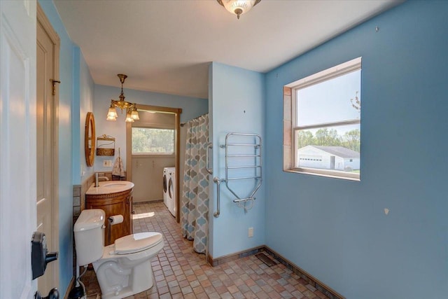 3756 E County Rd N, Milton, WI 53563 - full bath with washer and clothes dryer, toilet, baseboards, vanity, and a shower with shower curtain