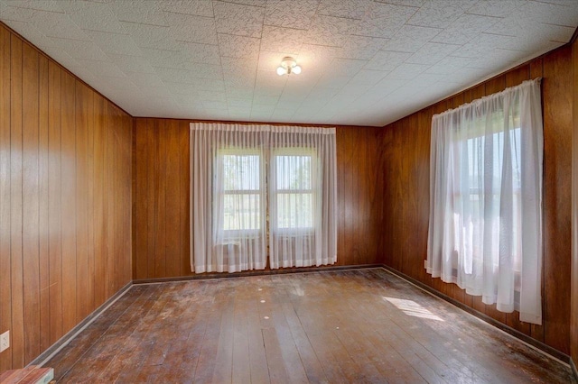 3756 E County Rd N, Milton, WI 53563 - spare room with wood-type flooring and wooden walls