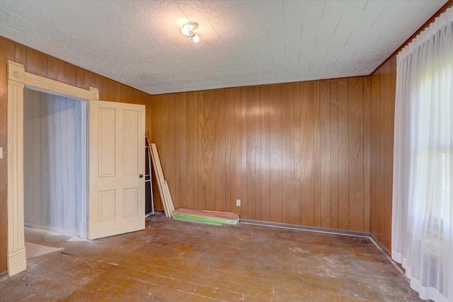 3756 E County Rd N, Milton, WI 53563 - spare room featuring wood walls and hardwood / wood-style flooring