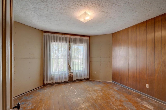 3756 E County Rd N, Milton, WI 53563 - unfurnished room with hardwood / wood-style flooring and wooden walls